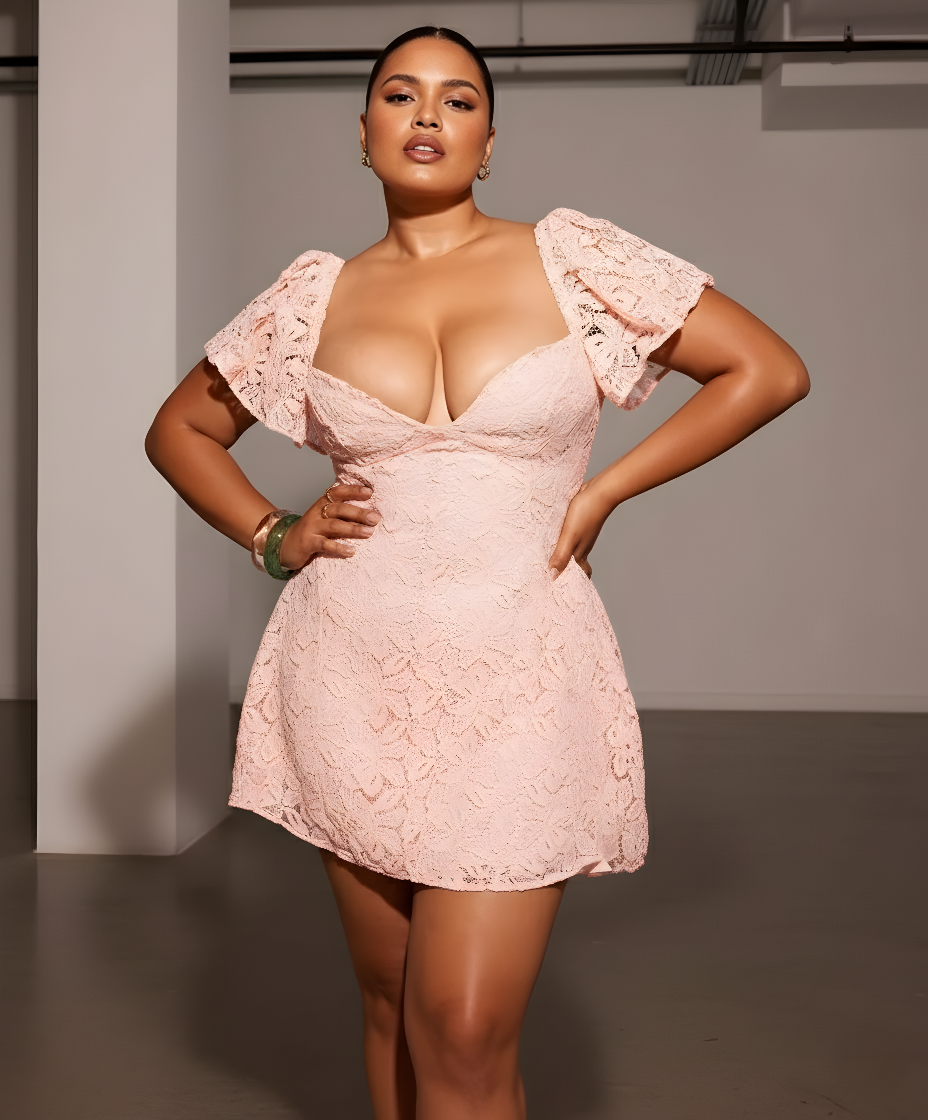 Woman wearing a pink lace dress in an indoor setting