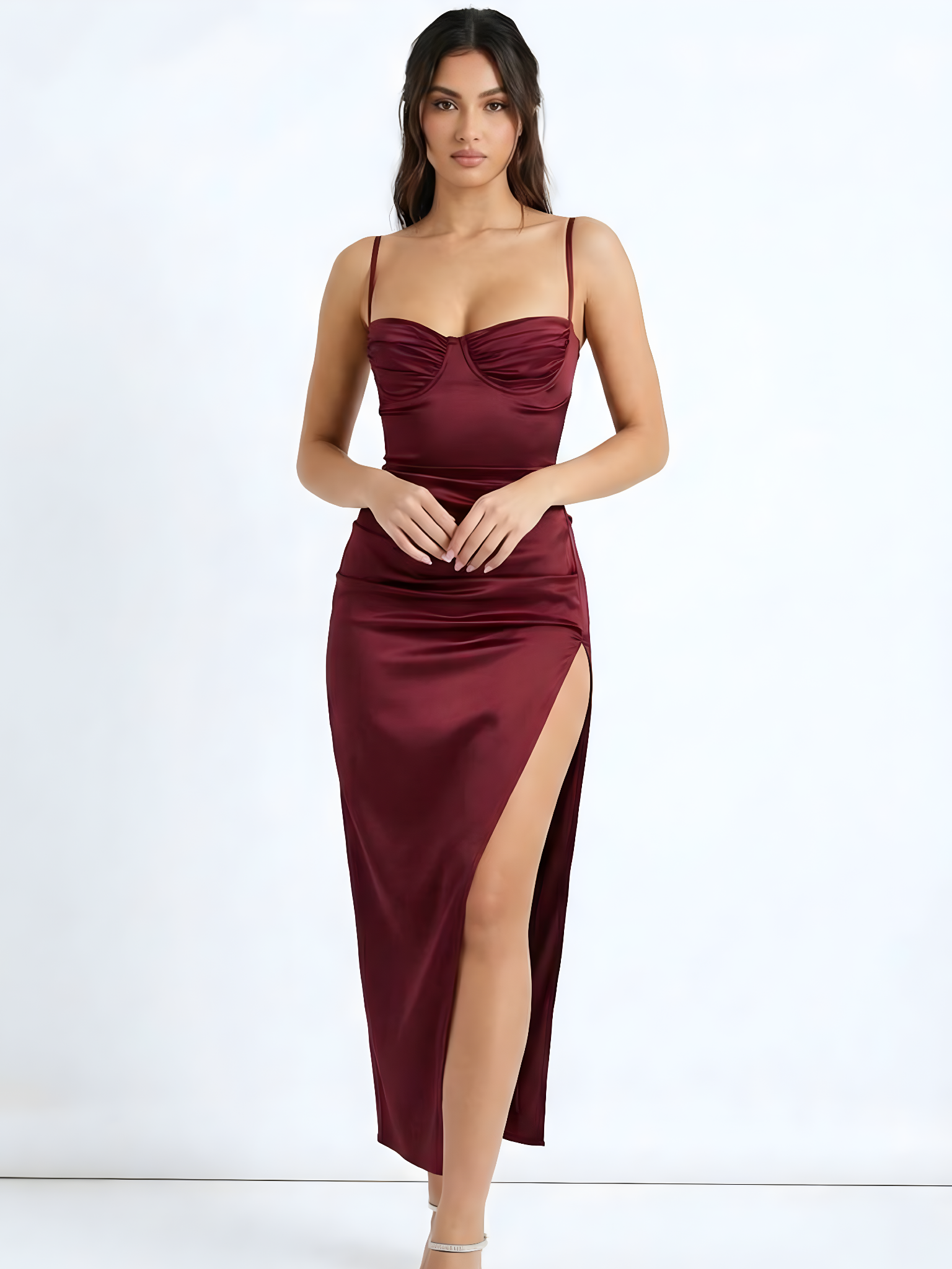 Woman wearing a Wine Red dress with a slit on a white background